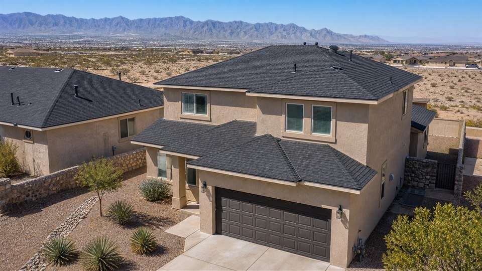 Finished charcoal shingle roof on a two-story home