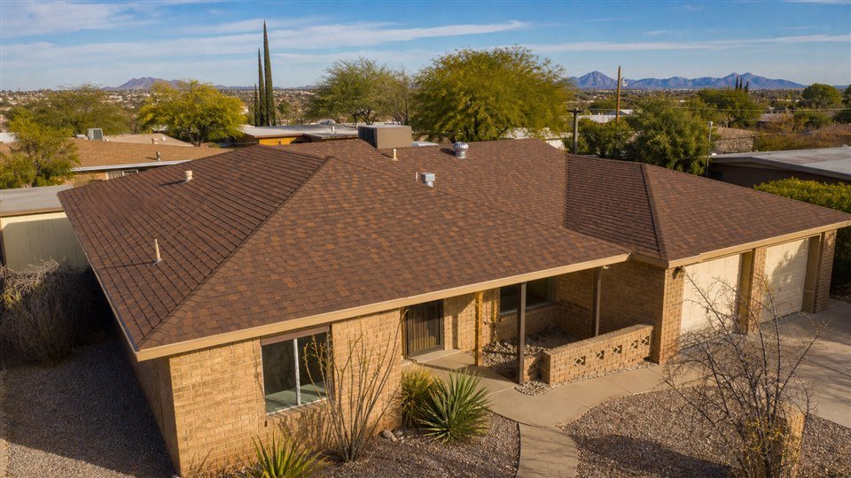 Warm brown architectural shingle roof on an El Paso ranch home